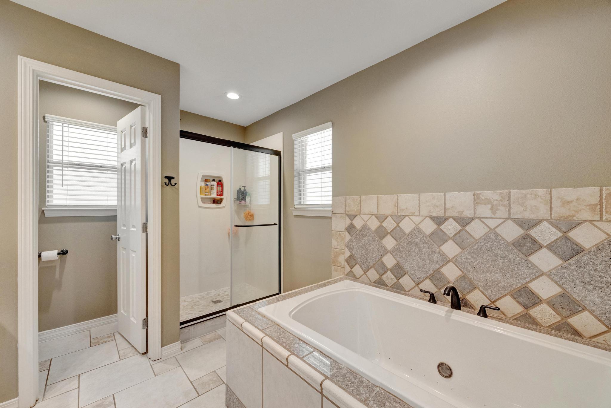 1141 Country Living Road Baker, FL 32531 - Photo 30 of 60 a bathroom with a tub and a sink