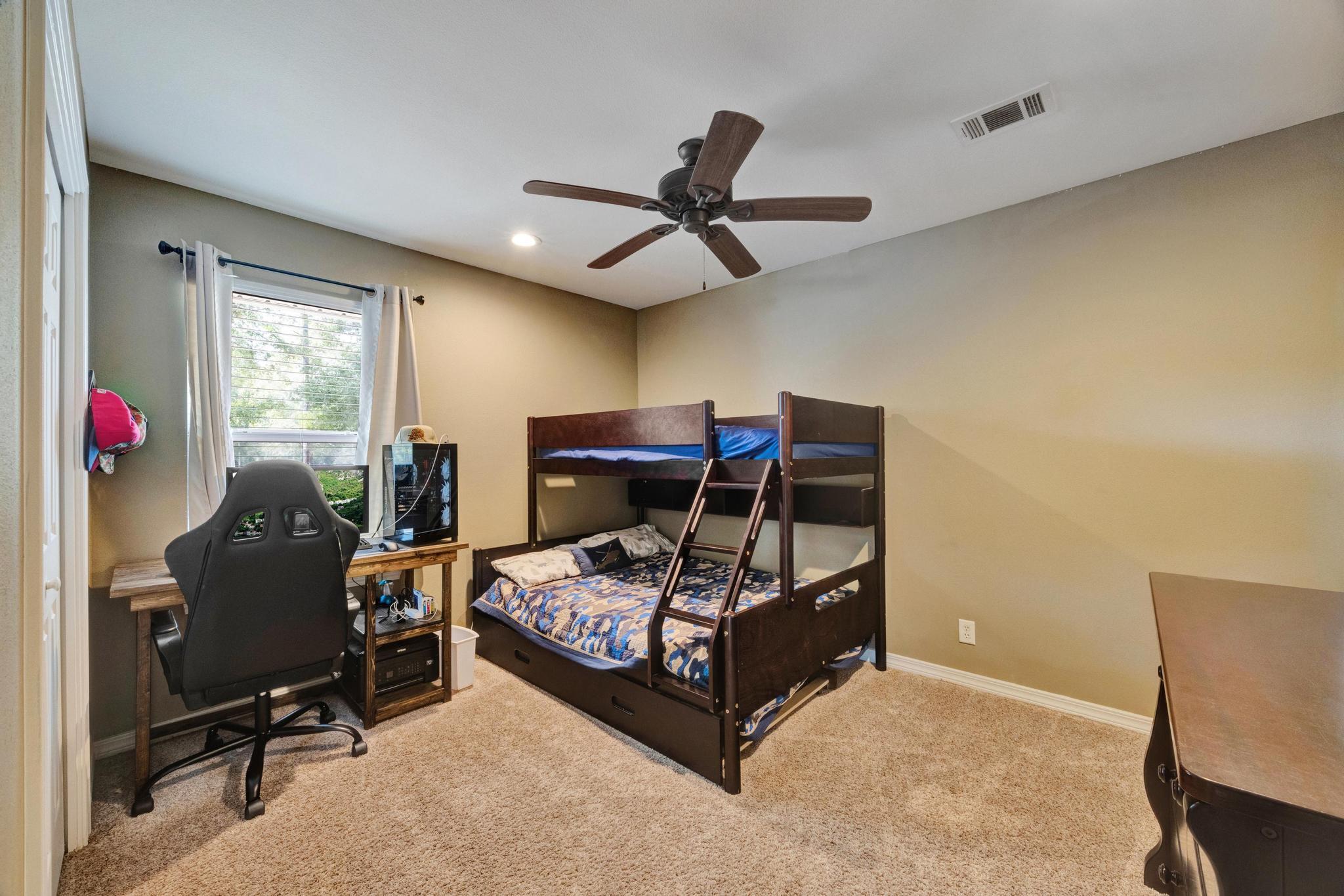 1141 Country Living Road Baker, FL 32531 - Photo 33 of 60 a bedroom with a bed a desk and chair with wooden floor