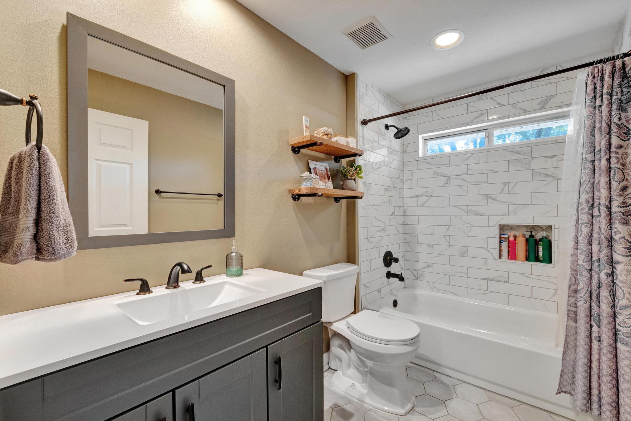 1141 Country Living Road Baker, FL 32531 - Photo 34 of 60 a bathroom with a granite countertop sink toilet a mirror a vanity and shower