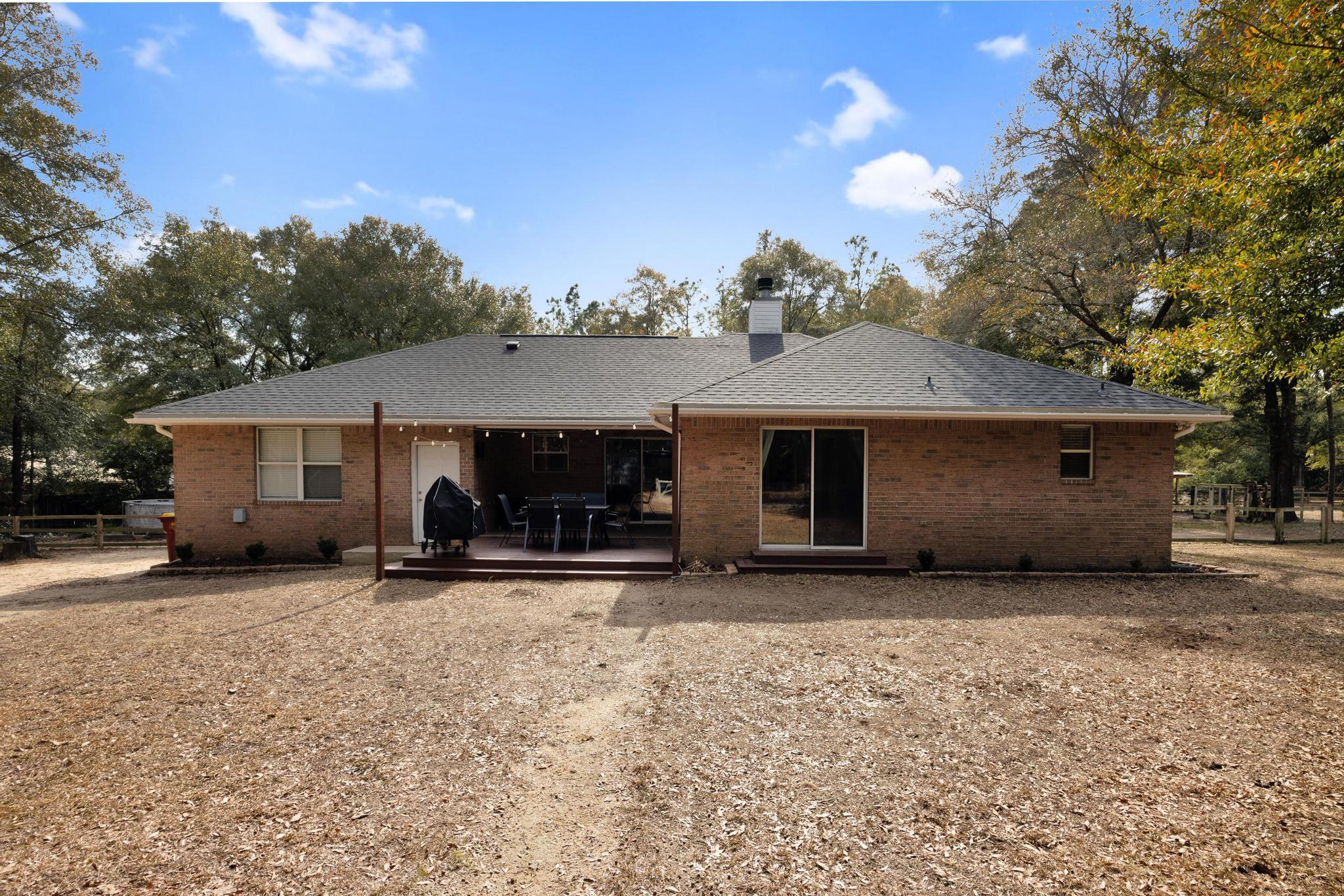 1141 Country Living Road Baker, FL 32531 - Photo 41 of 60 a view of a house with a patio