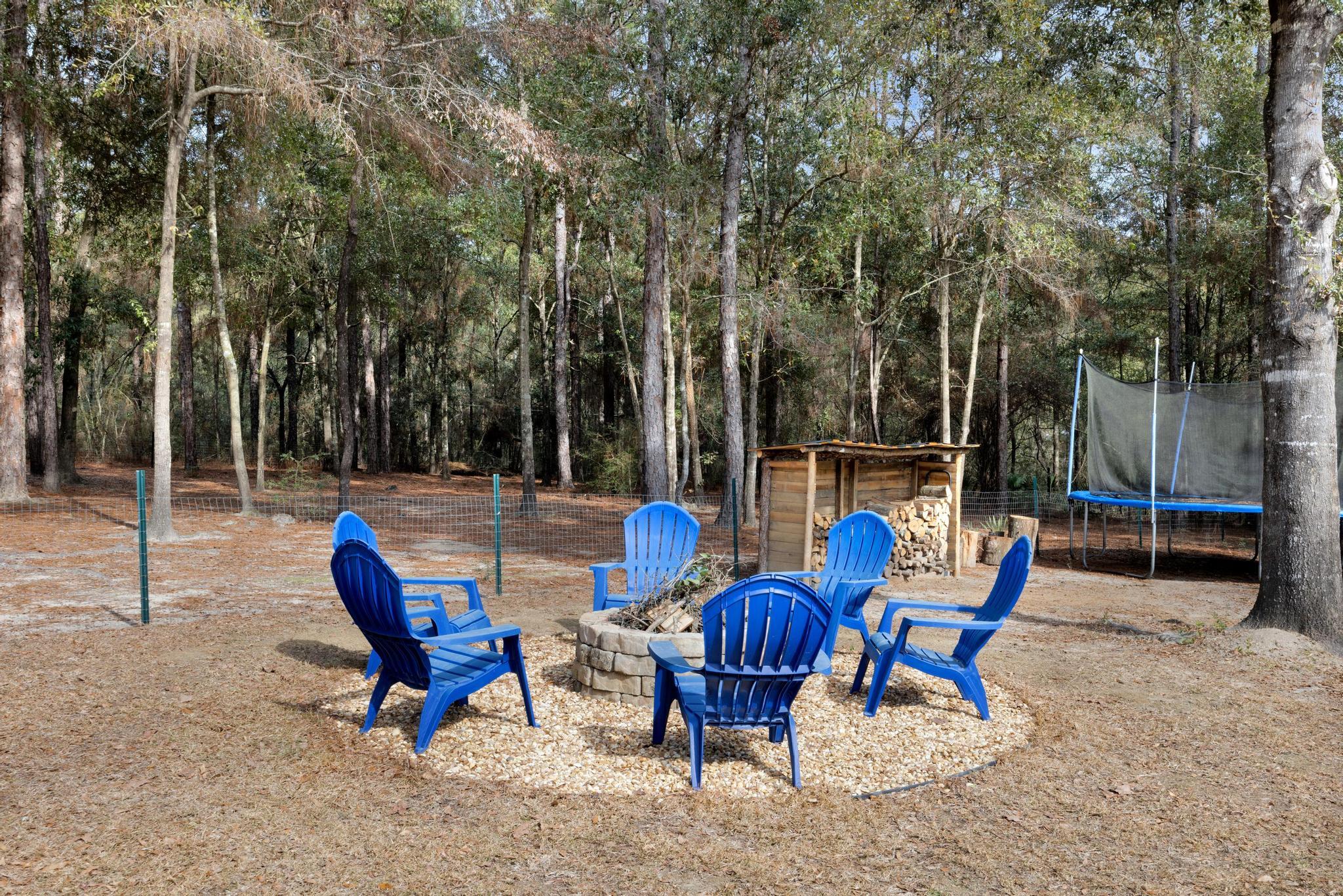 1141 Country Living Road Baker, FL 32531 - Photo 47 of 60 a view of backyard with outdoor seating and trees