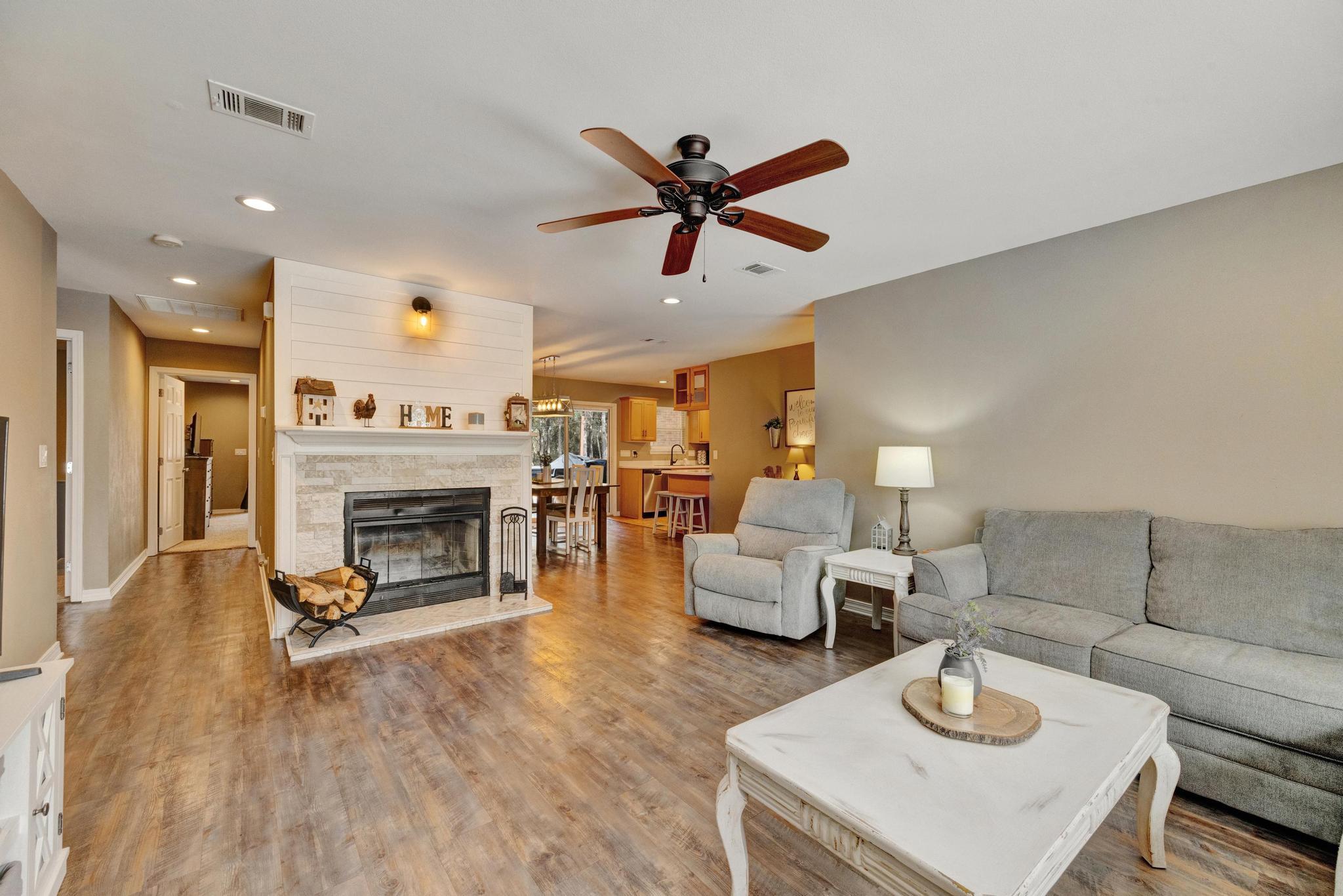 1141 Country Living Road Baker, FL 32531 - Photo 7 of 60 a living room with furniture and a fireplace