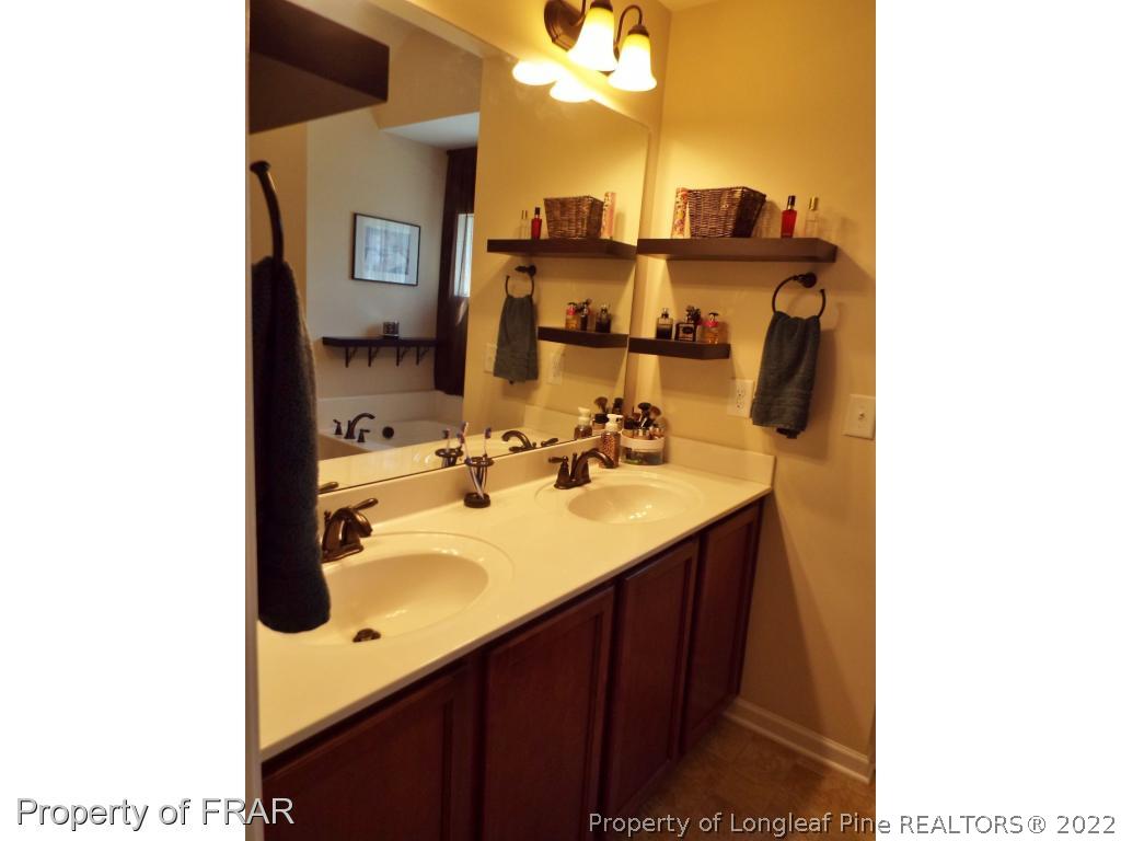 14 Citadel Street Cameron, NC 28326 - Photo 21 of 33 a bathroom with a sink and a mirror