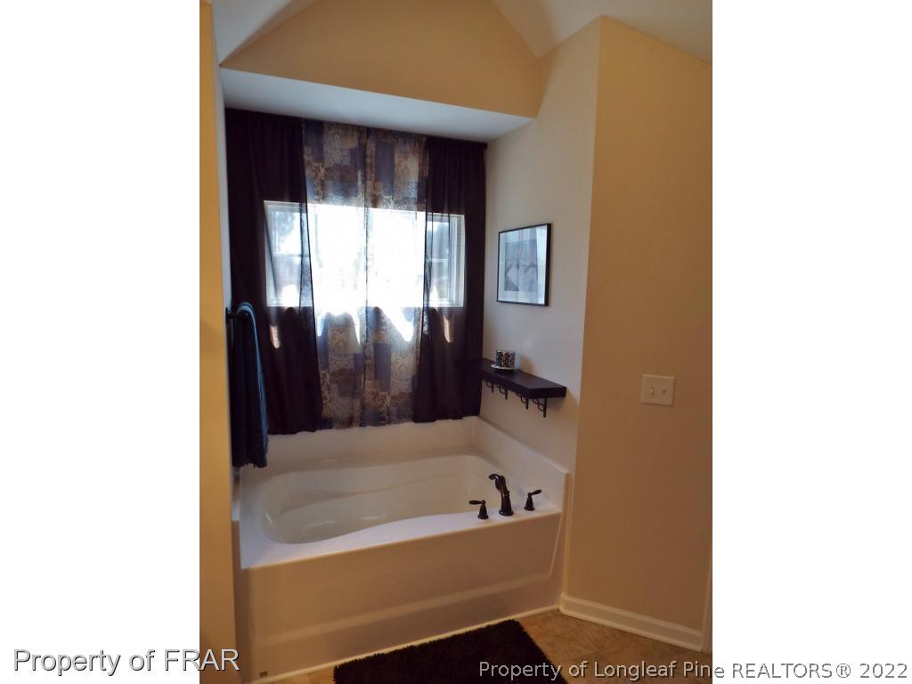 14 Citadel Street Cameron, NC 28326 - Photo 22 of 33 a bathroom with a tub and shower