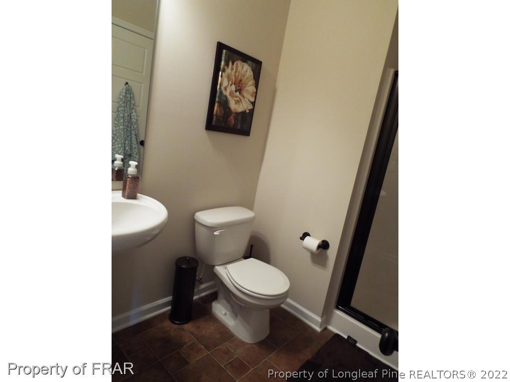 14 Citadel Street Cameron, NC 28326 - Photo 32 of 33 a white toilet sitting next to a bathroom sink