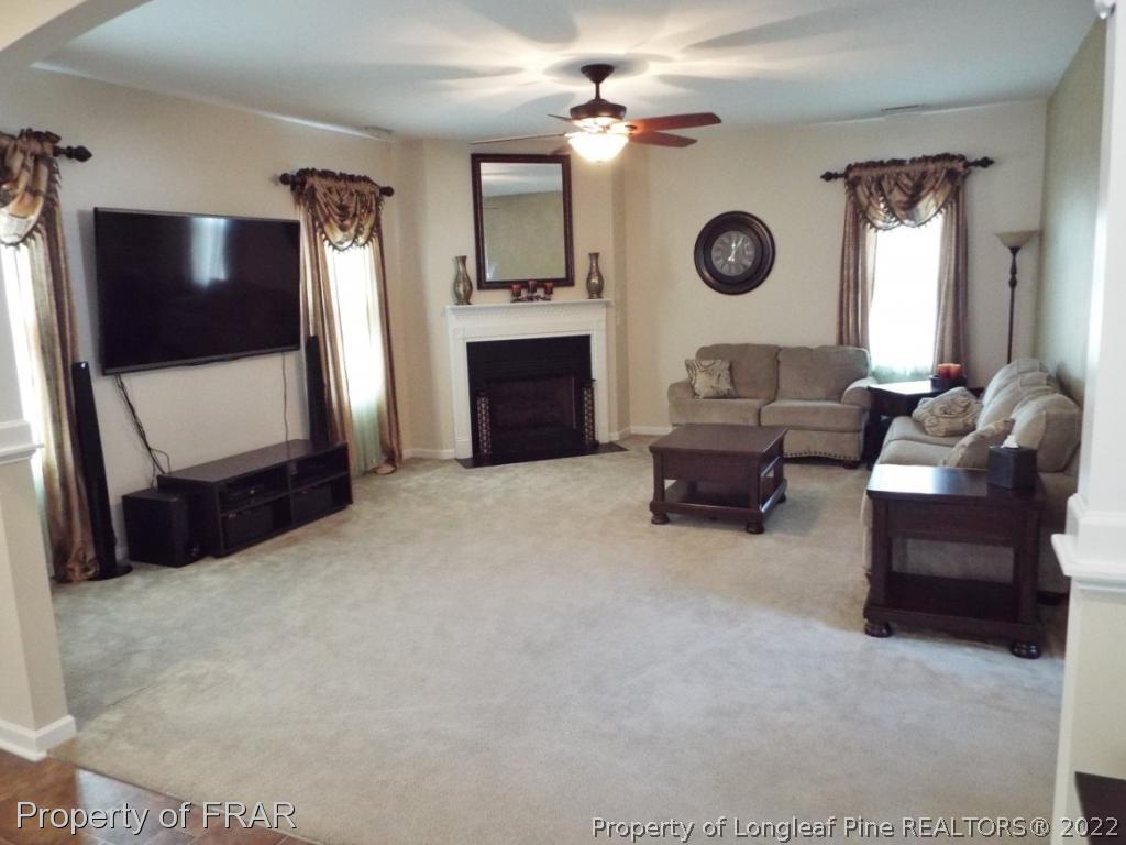 14 Citadel Street Cameron, NC 28326 - Photo 7 of 33 a living room with furniture a fireplace and a flat screen tv