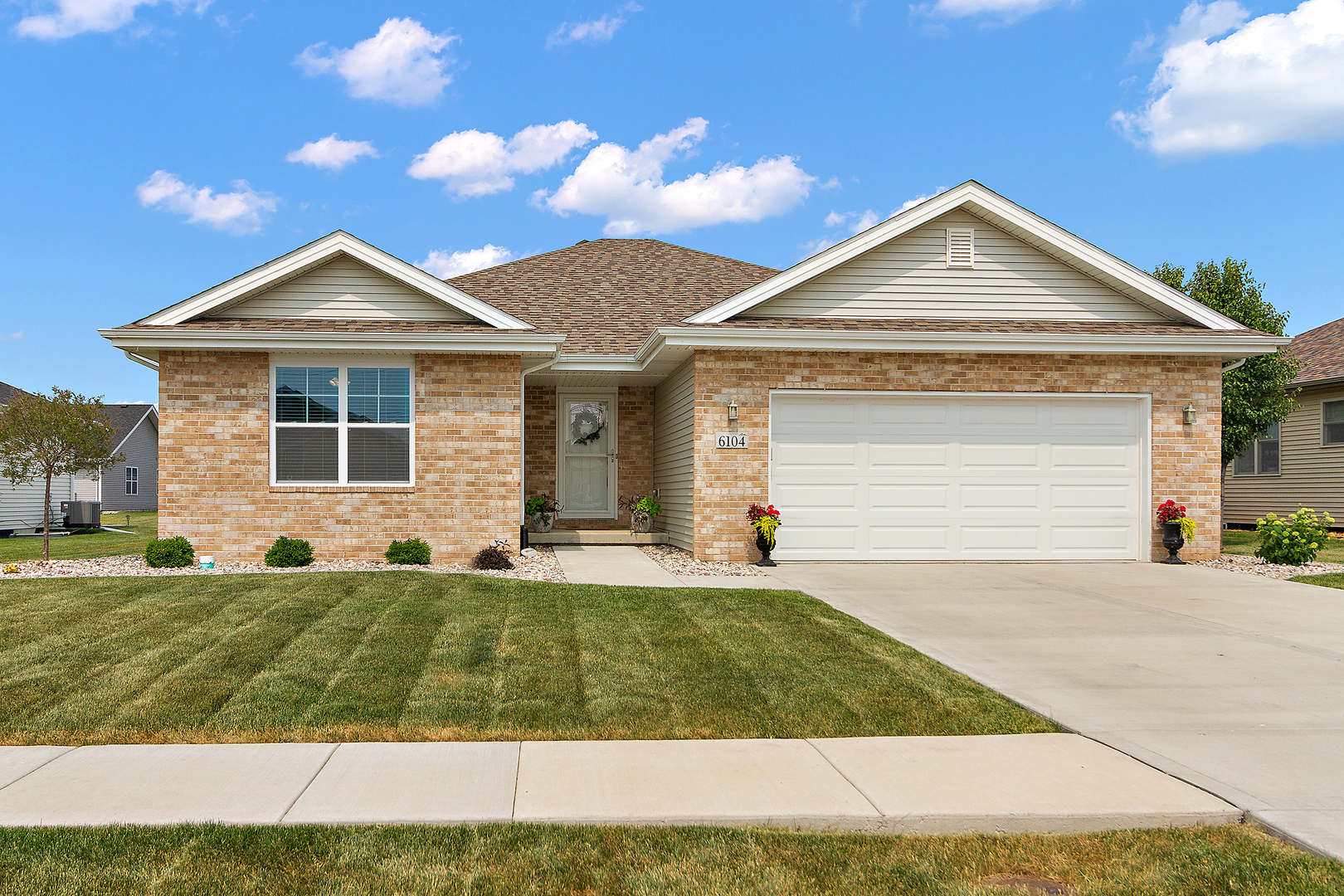 a view of a house with a yard and large tree