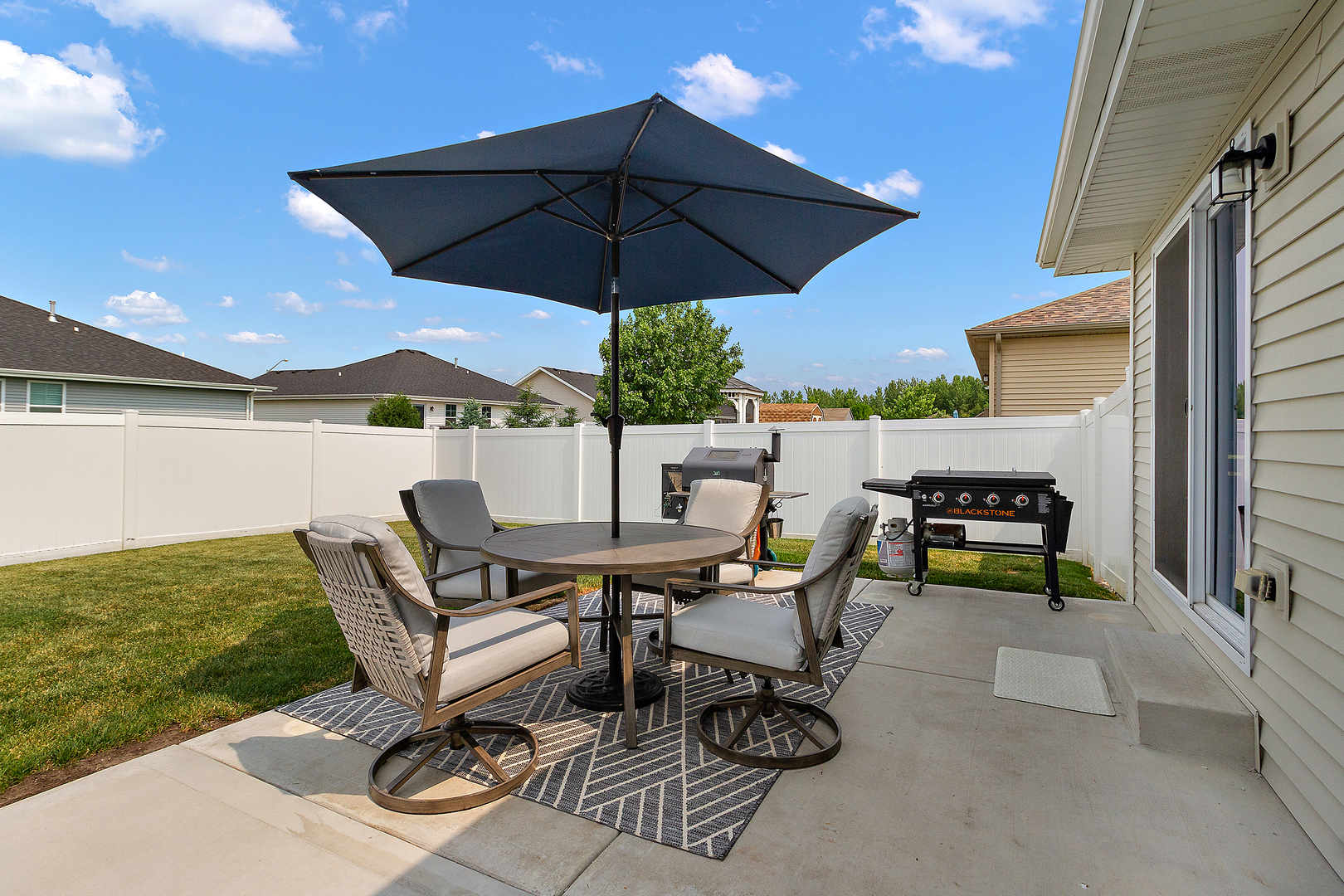 6104 Park View Drive Bourbonnais, IL 60914 - Photo 31 of 31 a view of an outdoor sitting area with furniture and umbrella