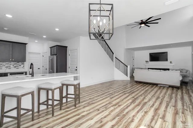 a view of a kitchen with furniture and a ceiling fan