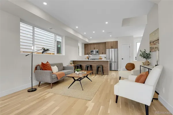 a living room with furniture and wooden floor