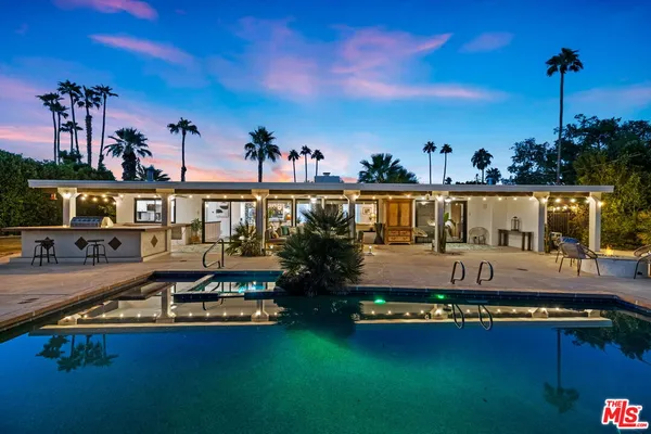 a view of swimming pool with outdoor seating