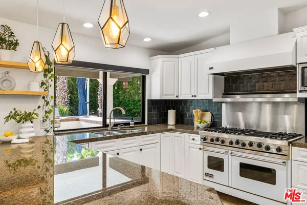 a kitchen with a stove a sink and a microwave