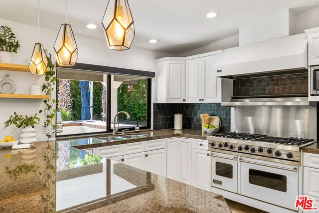 a kitchen with a stove a sink and a microwave