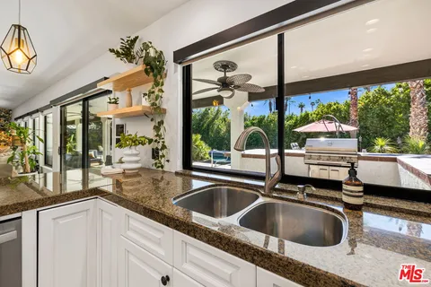 a kitchen with a sink and a large window