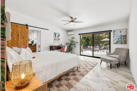 a bed room with a bed and a chair