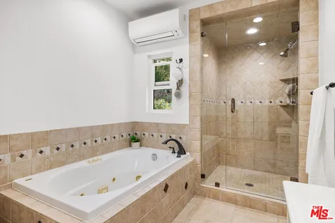 a bathroom with a bathtub and a shower