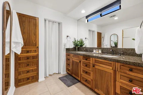 a spacious bathroom with a double vanity sink and a mirror