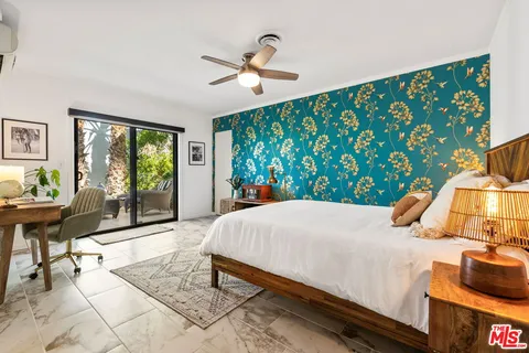 a bed sitting in a bedroom next to a window