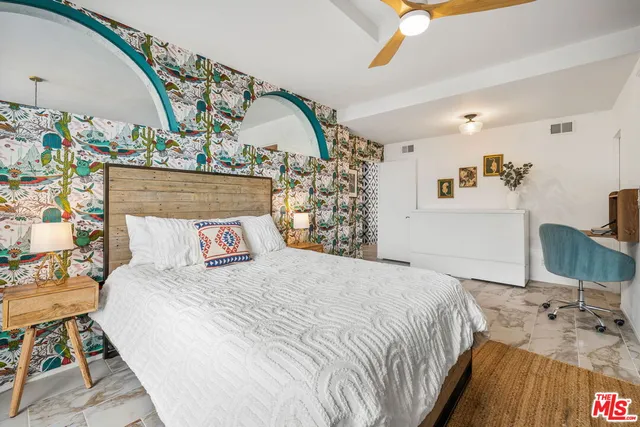 a bedroom with a bed and a dresser