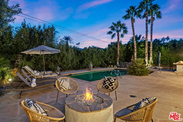 a swimming pool with outdoor seating