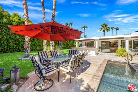 a view of a backyard with sitting area and furniture