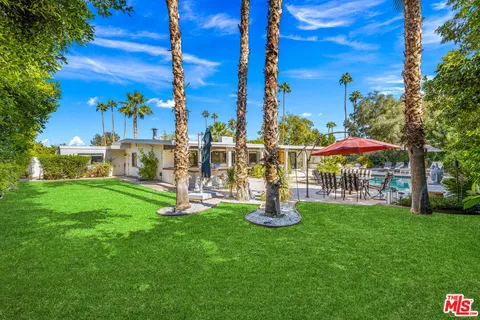 a view of a park with large trees