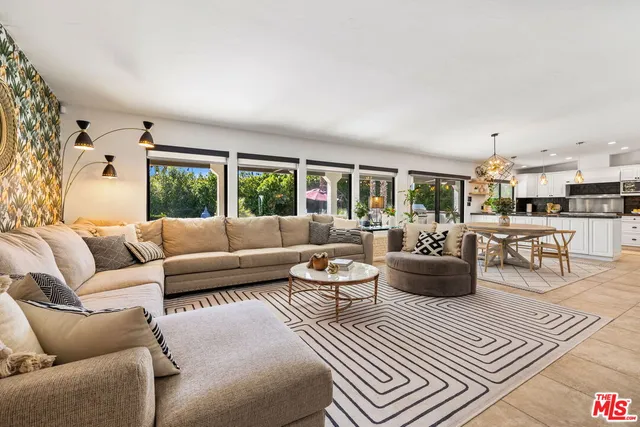 a living room with furniture a rug and a window