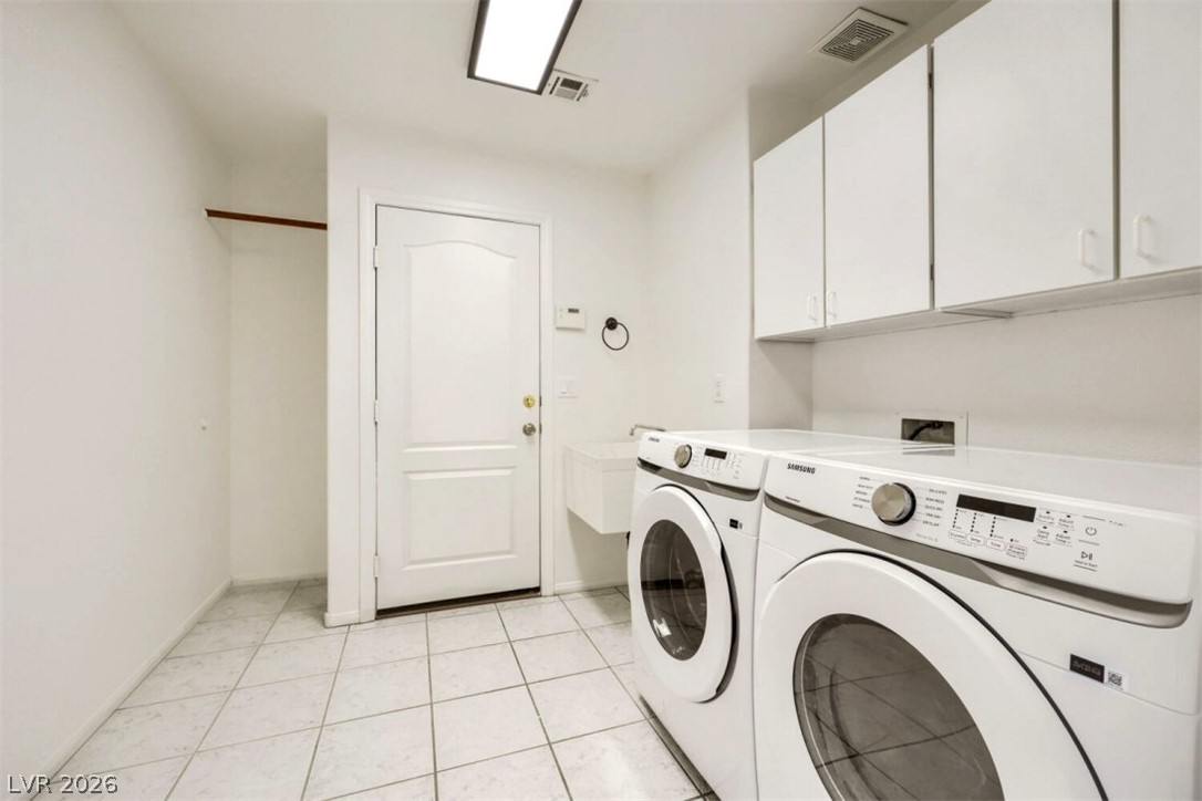 340 Kenya Road Las Vegas, NV 89119 - Photo 16 of 17 White cabinetry and tiled floors frame this functional utility space.