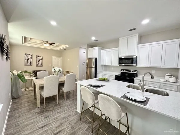 a kitchen with a dining table chairs and microwave