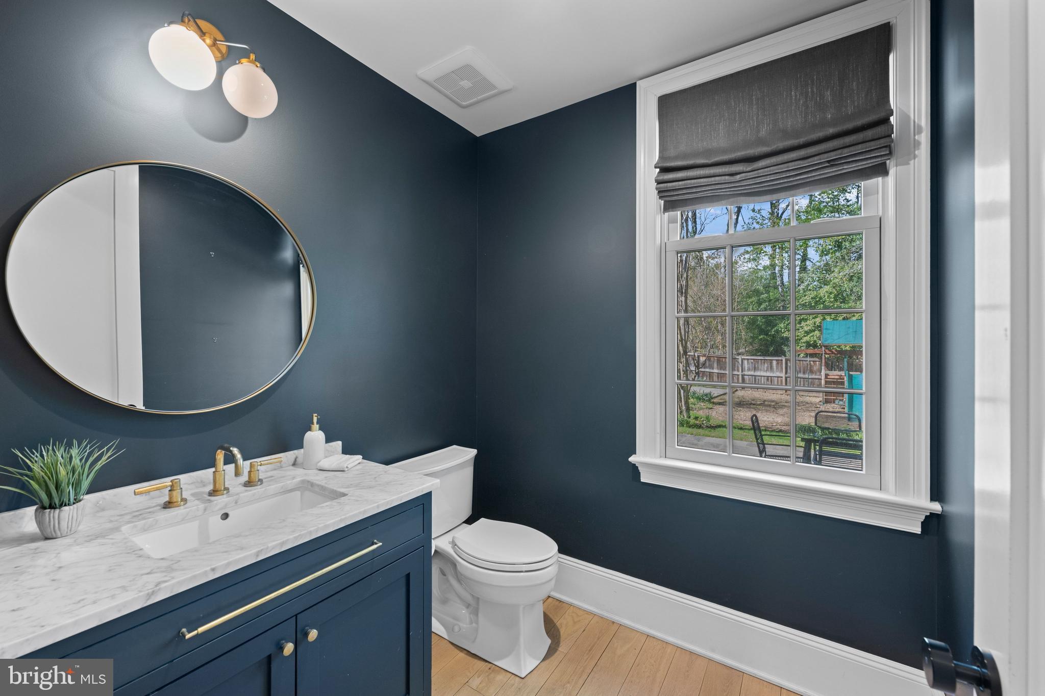 3849 Macomb Street Northwest Washington, DC 20016 - Photo 14 of 60 a bathroom with a toilet sink vanity granite and mirror