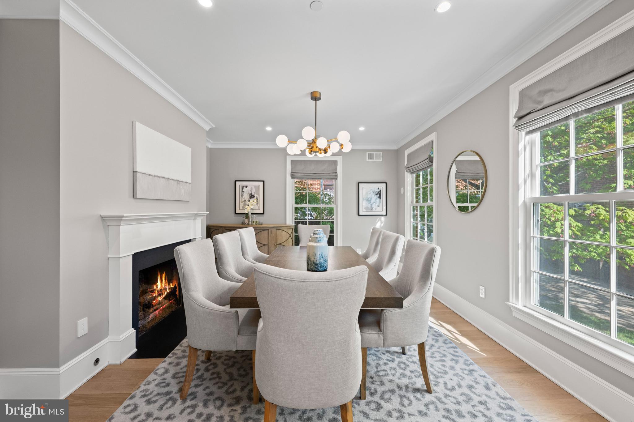 3849 Macomb Street Northwest Washington, DC 20016 - Photo 15 of 60 a dining room with furniture a fireplace and a chandelier
