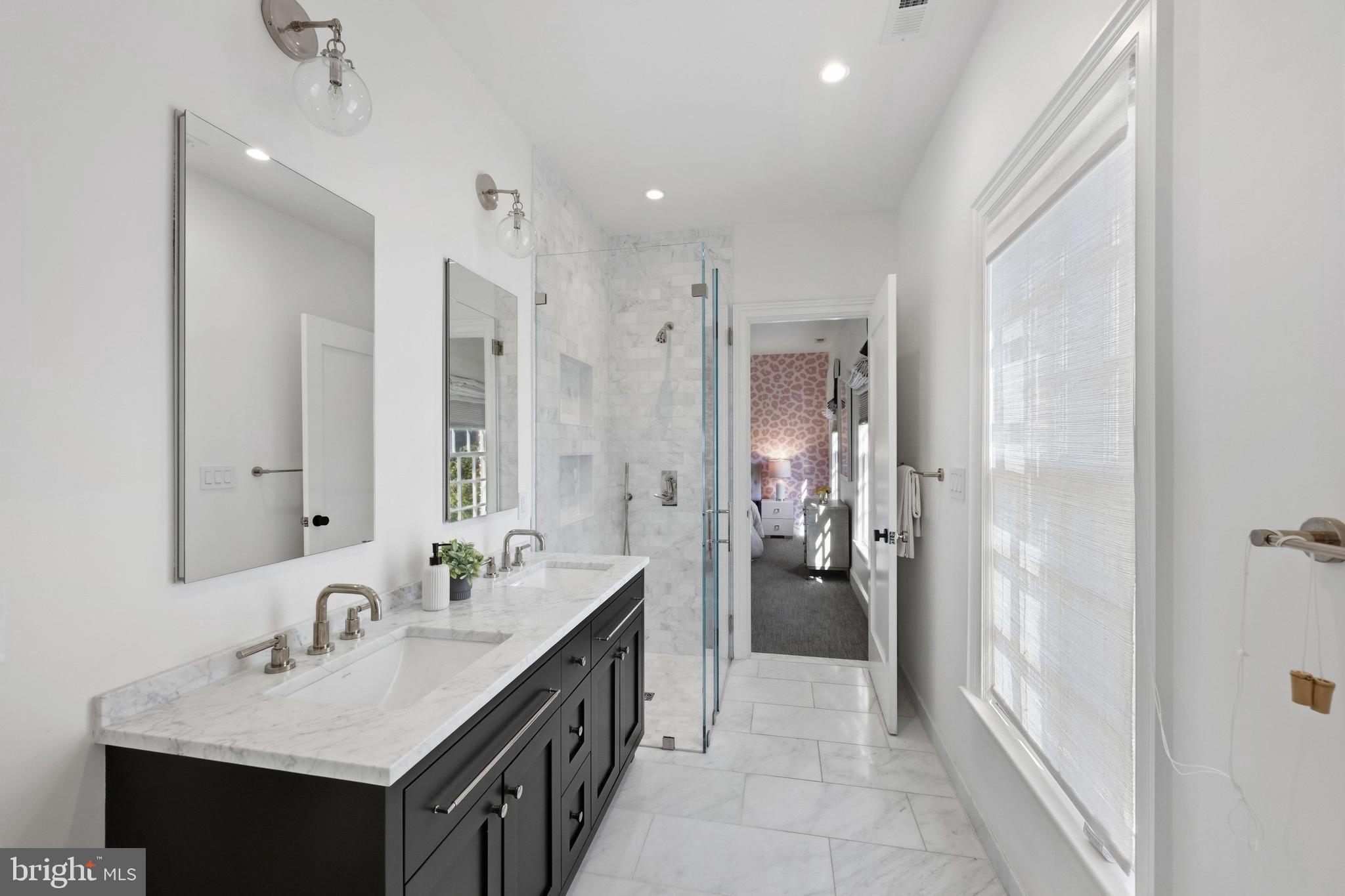 3849 Macomb Street Northwest Washington, DC 20016 - Photo 17 of 60 a bathroom with a sink tub shower and a mirror