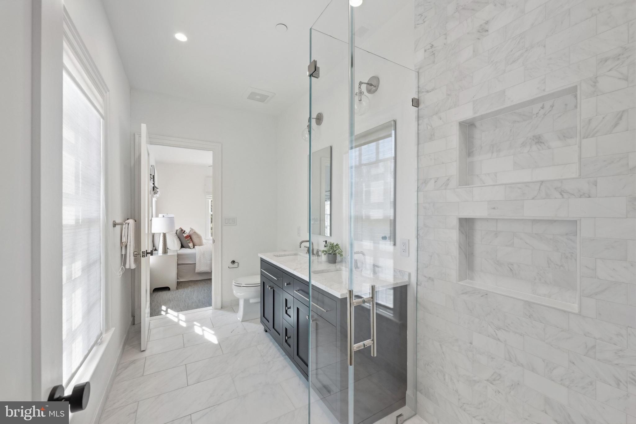 3849 Macomb Street Northwest Washington, DC 20016 - Photo 18 of 60 a large bathroom with a glass shower door
