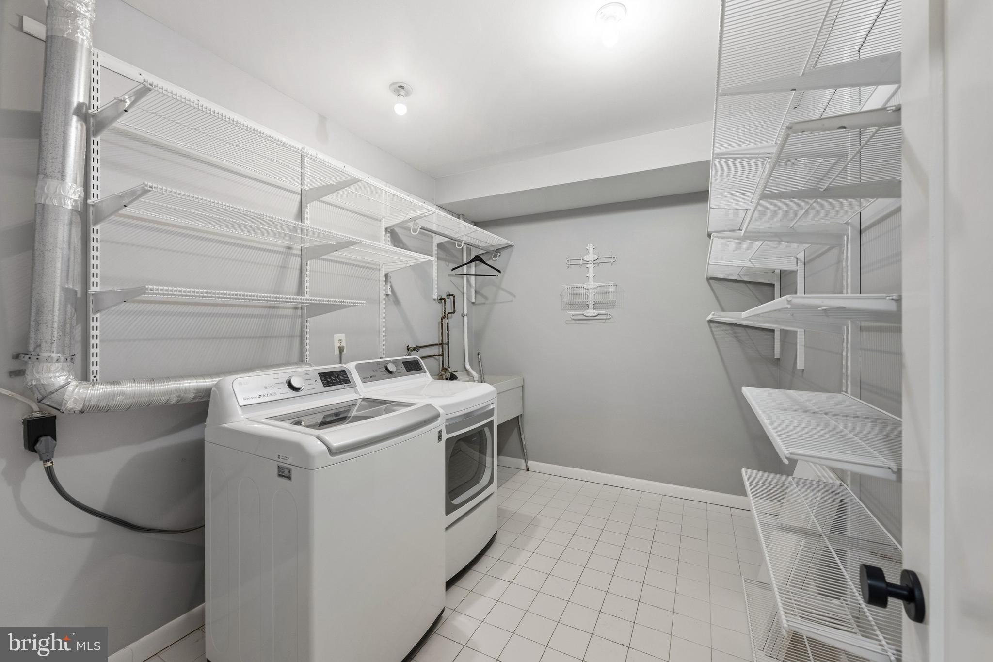 3849 Macomb Street Northwest Washington, DC 20016 - Photo 39 of 60 a utility room with cabinets washer and dryer