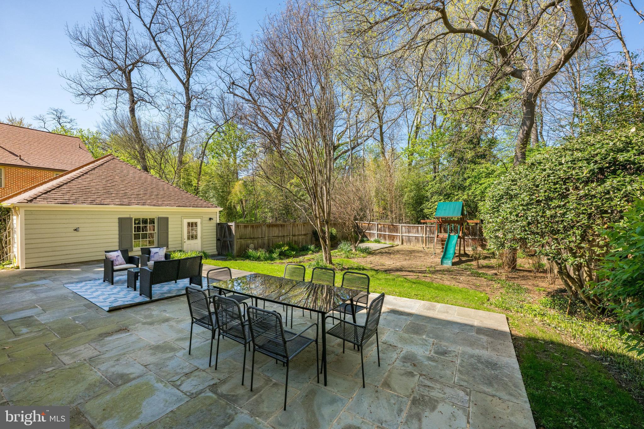 3849 Macomb Street Northwest Washington, DC 20016 - Photo 41 of 60 a view of a swimming pool with a table and chairs under an umbrella