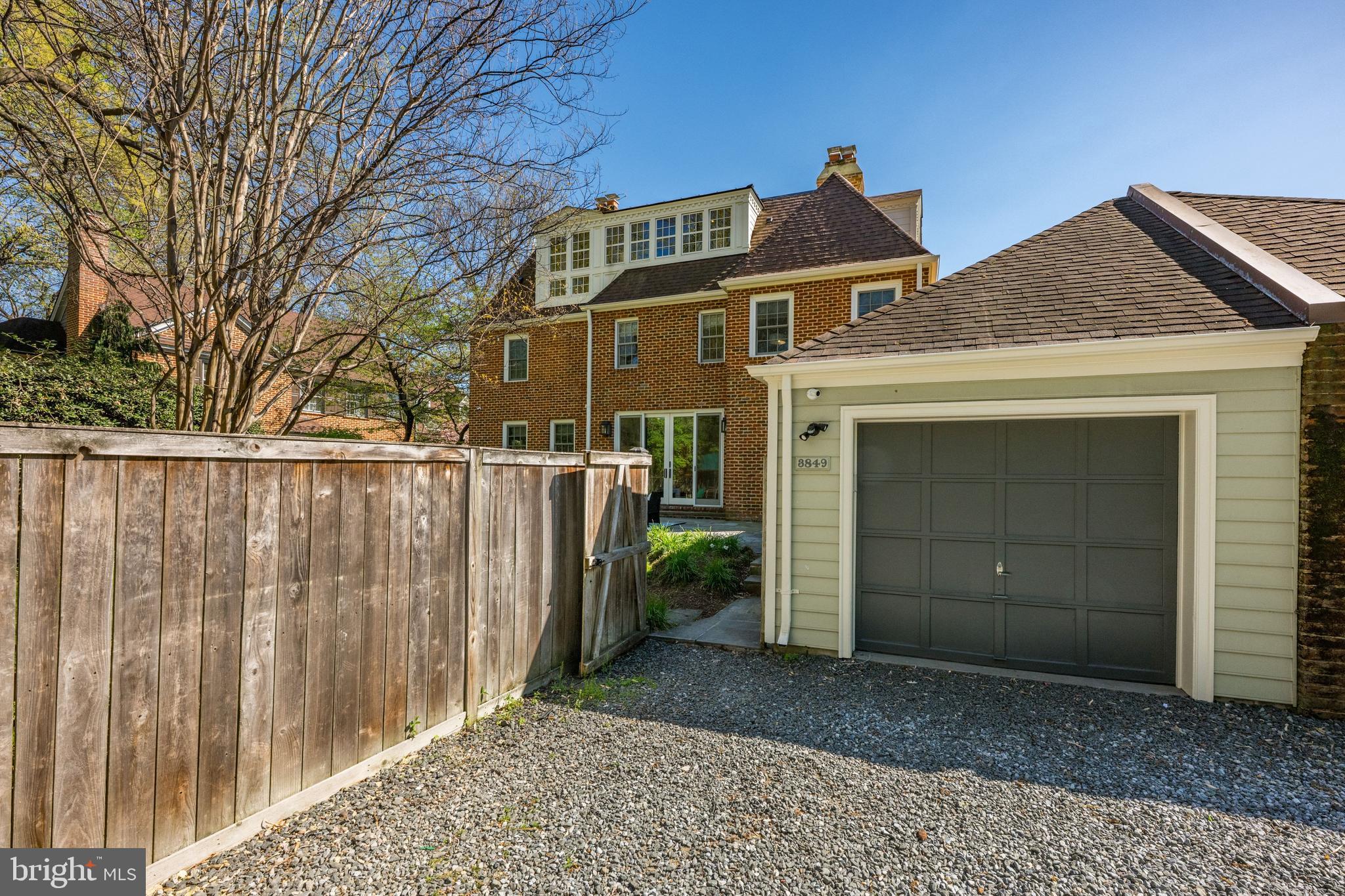 3849 Macomb Street Northwest Washington, DC 20016 - Photo 45 of 60 a front view of a house with a yard and garage