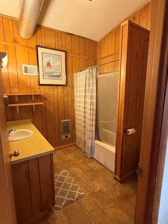 a bathroom with a shower and a sink