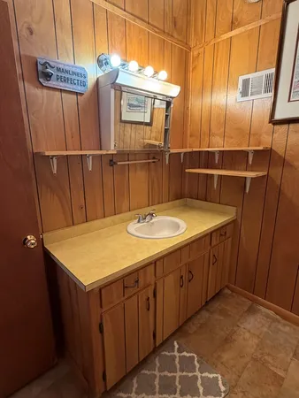 a bathroom with a sink a mirror and shower