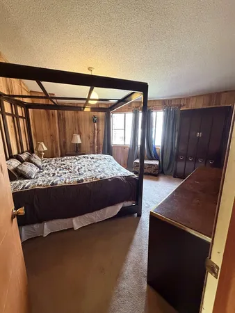 a bedroom with a bed and window