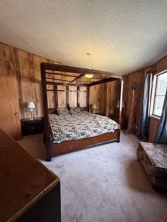 a bedroom with a bed and window