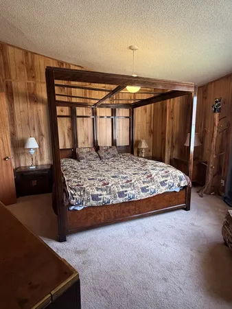 a bed sitting in a room next to a window