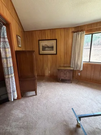 a view of an empty room with a fireplace