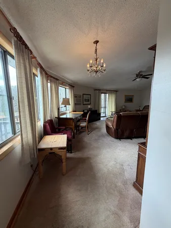 a living room with furniture and a chandelier