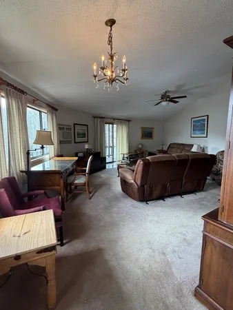 a living room with furniture and a chandelier