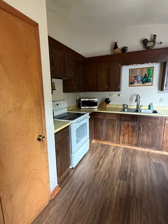 a kitchen with a sink and wooden cabinets