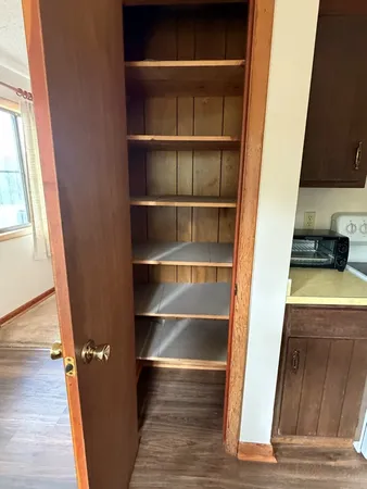 a view of walk in closet with empty racks