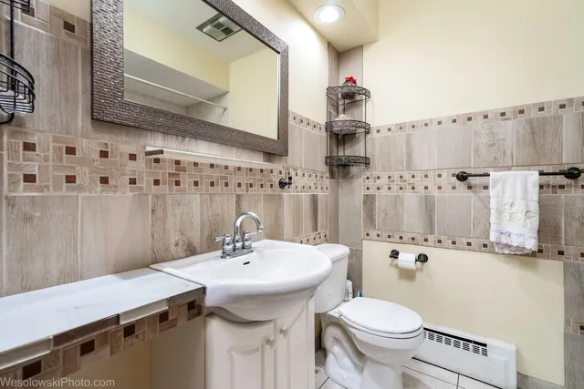 a bathroom with a sink a toilet and shower curtain