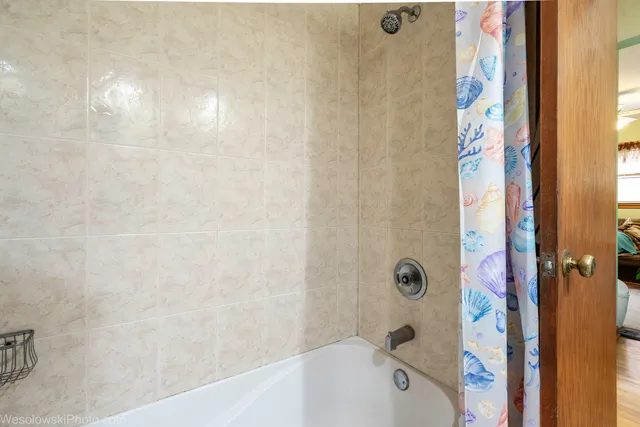 a bathroom with a bathtub and shower