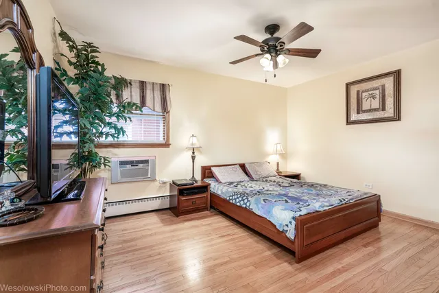 a bedroom with a bed window and a ceiling fan