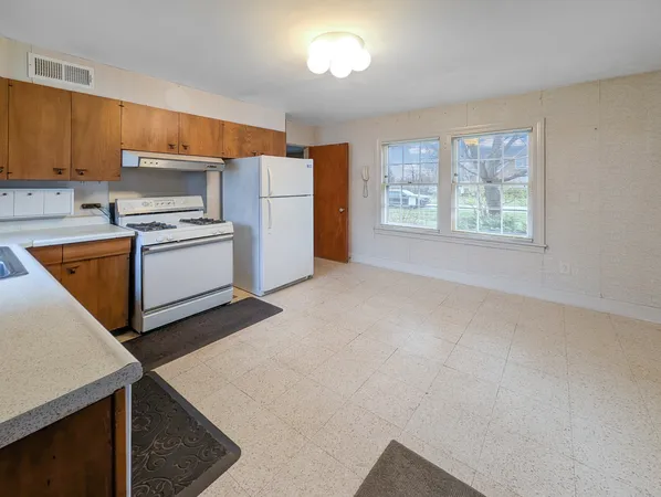 a kitchen with a stove a refrigerator and a sink